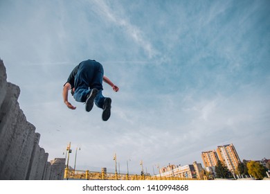 Parkour Man Below Blue Sky Doing Parkour Tricks, Backflip