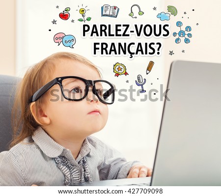 Parlez vous Francais (Do you speak French) texts with toddler girl using her laptop