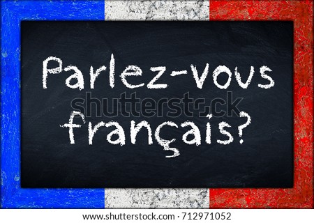Parlez-vous francais  (translation: do you speak french) language education concept on chalkboard blackboard with wooden france flag frame