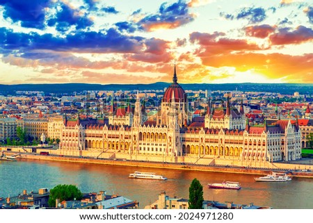 Parliament and riverside in Budapest Hungary with sightseeing ships during amazing sunset. Parliament and Danube river in Hungary