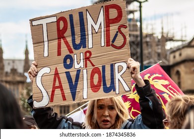 PARLIAMENT SQUARE, LONDON, ENGLAND- 14 December 2020: Protester Holding A 'Trump Is Our Saviour' Sign At An Anti-lockdown Protest Organised By The National Alliance For Freedom From Lockdowns