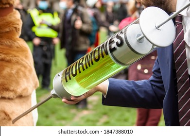 PARLIAMENT SQUARE, LONDON/ENGLAND- 24 October 2020: Protester Injecting A Pantomime Cow With Hormones At The 'STOP TRUMP, STOP THE TRADE DEAL' Protest, Against Hormone-laced Beef Among Other Issues