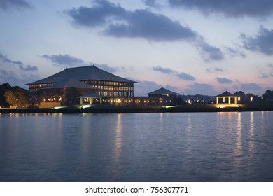 Parliament Of Sri Lanka Building, Sunset Evening Sky Clouds, Lake Water In Lights 