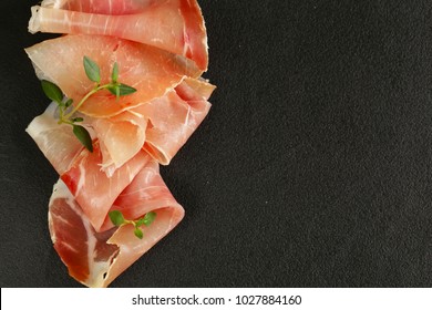 Parma Ham Thin Slices On A Black Stone