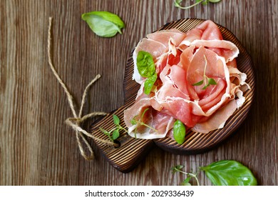 Parma italian dried ham on a wooden board - Shutterstock ID 2029336439