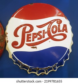 Parma, Italy - March 17, 2022: Vintage Pepsi Cola Advertising In The Shape Of A Bottle Cap