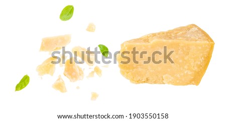 Parmesan cheese with basil leaves isolated on white background.