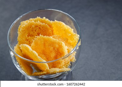 Parmesan Cheese Cracker Chips An A Glas Bowl Simple Easy Snack For Party Or Event On A Dark Stone Backgrond