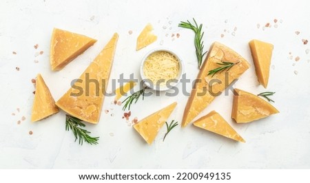 Parmesan cheese, Hard cheese, rosemary on a light background. Long banner format. top view.