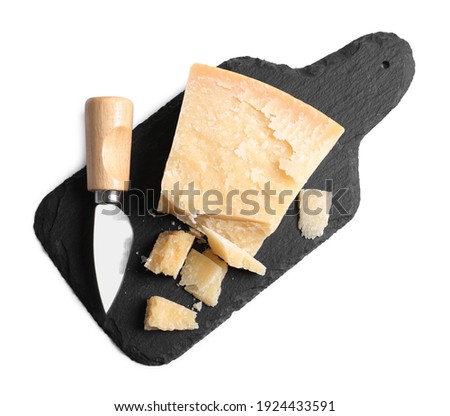 Parmesan cheese with knife and slate plate on white background, top view