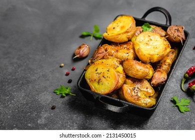 Parmesan Pesto Roast Potatoes In Cast Iron Skillet On Dark Background. Top View, Copy Space.