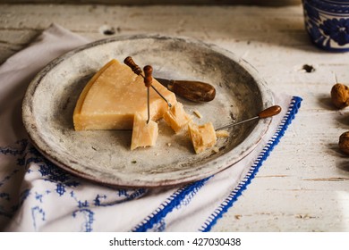 Parmesan Reggiano Cheese And Wax Paper. Rustic Style.