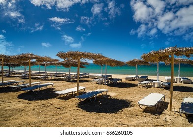 Paros island, Cyclades, Greece. Straw umbrellas and beach loungers on Golden Beach. - Powered by Shutterstock