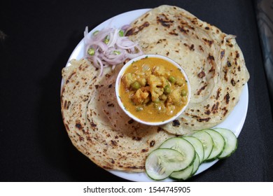 Parotta With Veg Kurma And Onion Salad