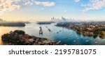 Parramatta river bays in Sydney city at sunny morning with fog in short aerial panorama towards City of Sydney CBD skyline high-rise towers.