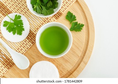 Parsley Juice And Cotton Pads. Ingredients For Preparing Homemade Eye Mask Or Face Toner. Natural Beauty Treatment Recipe, Zero Waste Concept. Top View, Copy Space