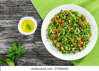 Parsley Salad Or Tabbouleh On White Platter, Easy And Healthy Classic Vegetarian Dish With Bulgur, Tomatoes, Parsley, Spring Onion And Mint, Olive Oil On Dark Wooden Background,view From Above