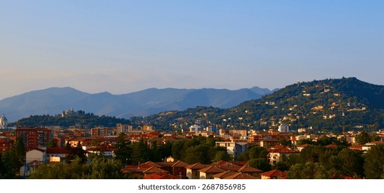Part 1: This elevated evening view of Brescia captures the character of the city, dense housing blocks, pockets of greenery, and historical and modern structures. Italy, August 17, 2025