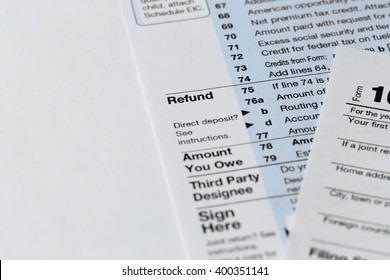 Part of the 1040 Individual Income Tax Return Form for 2015 year on the white wooden desk, close up