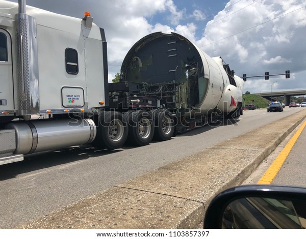 part of an airplane on the
highway on a truck escorted by police in Tampa, Florida June 2,
2018