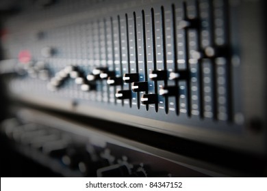 Part of an audio sound mixer with buttons and sliders - Powered by Shutterstock