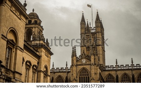 Part of Bath Abbey ,against background of rainy clouds.