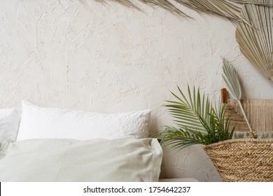 Part Of The Bedroom
Interior Stylized Under A Tropical Theme. 
Tropical Leafs At Plaster Wall With Copy Space