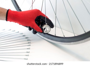 part of a bicycle wheel, adjusting the spokes of the wheel with a tool, close-up, on an isolated white background - Powered by Shutterstock