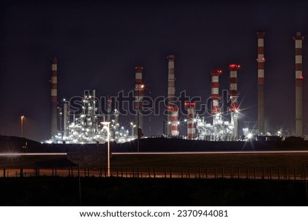 Part of a big oil refinery and powerplant by night