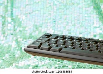 Part Of Black Computer Keyboard Floating On Mint Green And White Bokeh Background. Copy Space.