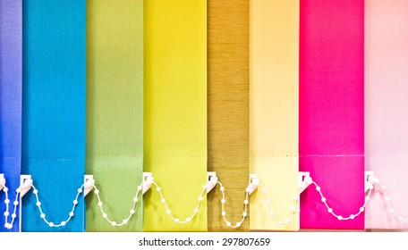 Part of a blind with multiple colours as a background