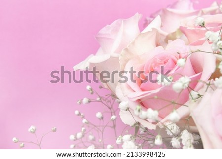 Part of bouquet of rose flowers on pink background for holiday card