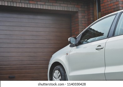 Part Of A Car Parked In Front Of The Garage Door