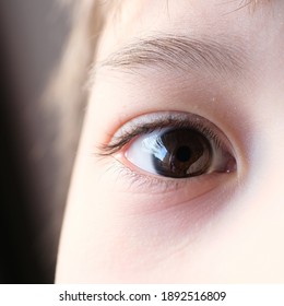 part of the child's face, human eye looking at the camera, the concept of surveillance, peeping, tracking