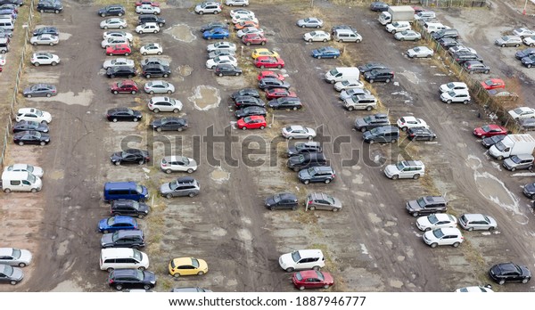 Part of a city outdoor dirt parking lot in cloudy\
weather, panoramic top\
view\
