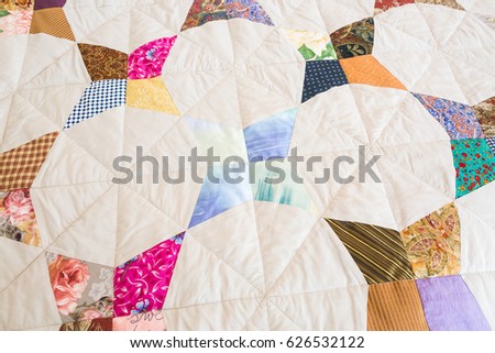 Part of color patchwork quilt as background. Handmade, art, hobby concept. Colorful Scrappy blanket. top view.