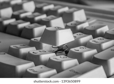 Part of a computer keyboard with a raised button close-up