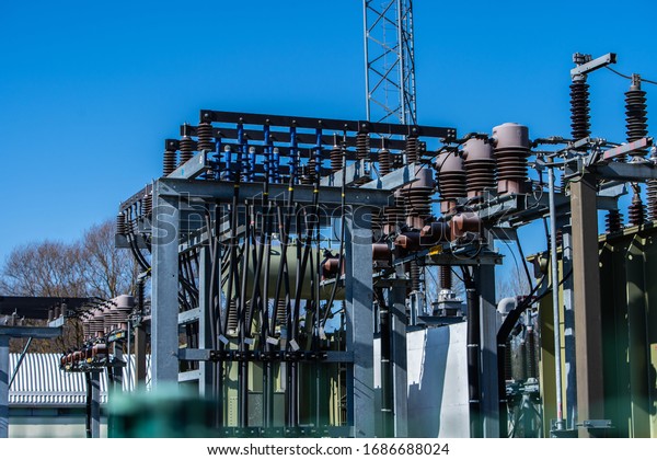 Part of electric\
station engineering construction on a plant, high voltage\
transformer, electrical substation, copper bars and insulators of\
electricity transformers