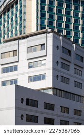 Part of the facade of a modern building with rectangular windows.