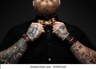 Part Of Face Of The Man With Beard In Black Shirt And Leopard Bow Tie. Isolated On Dark Gray Background