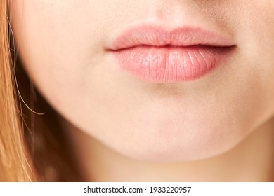Part of face,young woman close up. Plump lips without makeup