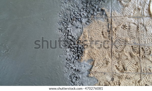 The part of fresh\
concrete, steel and sand during concrete car parking floor\
construction. Text space or area for marketing or construction\
business information