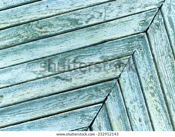 Part\
of  green wooden garage door divided into two parts\
