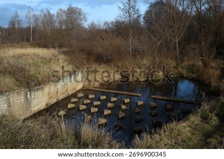 Part of a hydraulic engineering structure called a hydraulic jump. Part of the river dam, top view. The hydraulic jump consists of a stilling basin with Baffle block and a Baffle weir. 