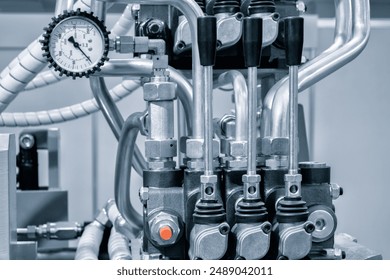 Part of a hydraulic industrial machine, control levers of a hydraulic machine, industrial concept