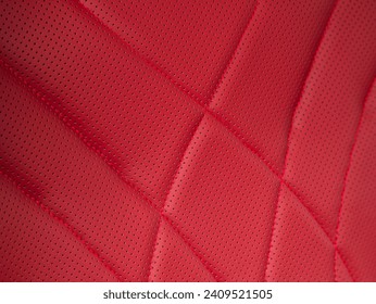 Part of leather car headrest seat details. Сlose-up red   perforated leather car seat. Skin texture