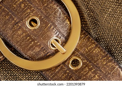 Part Of Leather Handbag Of Bronze Brown Color With Golden Bag Buckle, Metal Detail Close-up, Background. No Name, No Logo