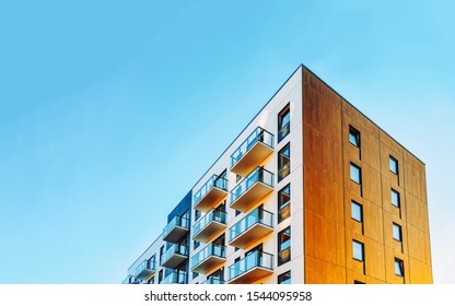 Part of Modern residential apartment with flat building exterior. Detail of New luxury house and home complex. Fragment of City Real estate property and condo architecture. Copy space. Blue sky - Shutterstock ID 1544095958