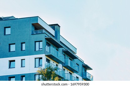 Part in Modern residential apartment flat building exterior. Detail of New luxury house and home complex. Fragment of City Real estate property and condo architecture. Copy space. Blue sky