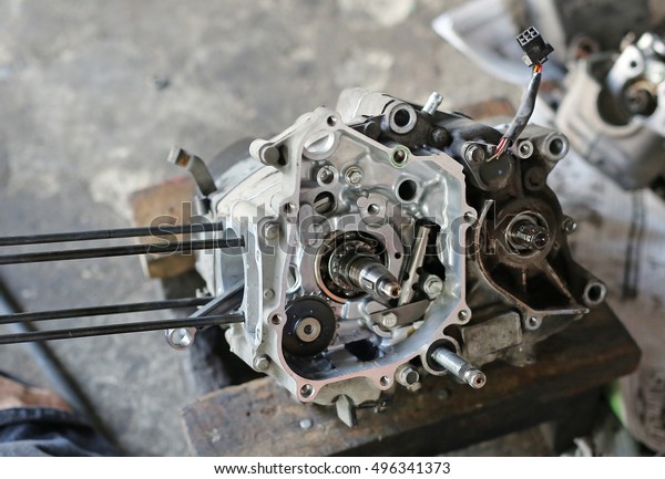 Part of a motorcycle engine in repair of the damage,\
Garage shop